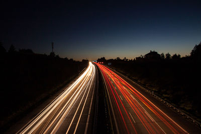 High angle view of light trails on highway at night