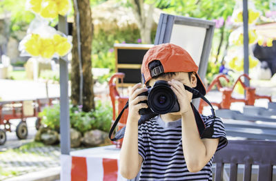 Boy photographing through camera