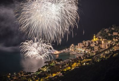 Firework display over city at night