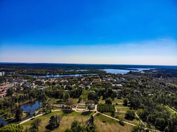 High angle view of city and sea against blue sky