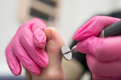 Cropped hand holding dental equipment