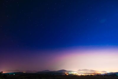 Scenic view of illuminated mountain against sky at night