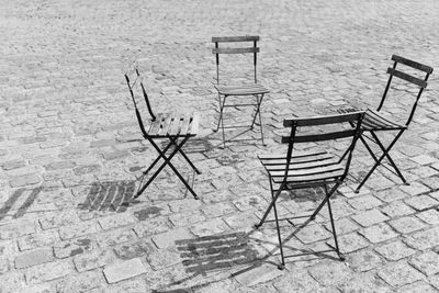 High angle view of empty chairs on table by street