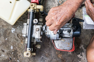 Close-up of man working on machine