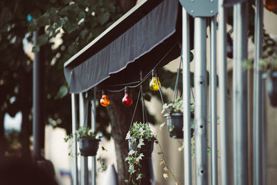 Close-up of illuminated lighting equipment hanging in building