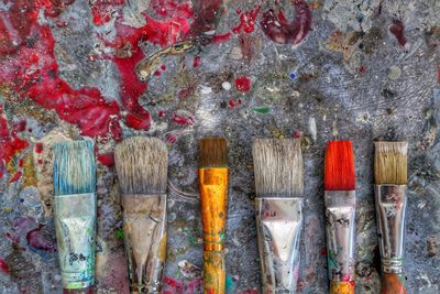 Directly above shot of paintbrushes on table