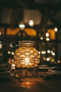 Close-up of illuminated lighting equipment on table