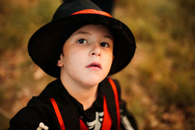 Close-up portrait of boy wearing hat during halloween at forest