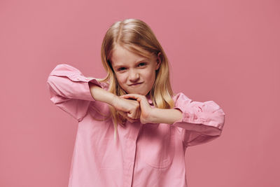 Portrait of young woman against yellow background