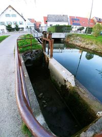 High angle view of canal by buildings against sky