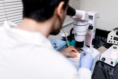 Male scientist using microscopy in laboratory