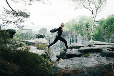 Man standing on rocks in forest