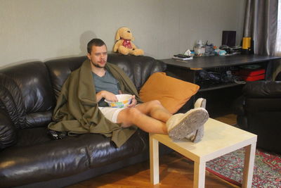 People sitting on sofa at home