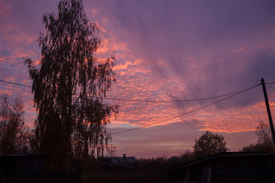 Low angle view of silhouette tree against romantic sky