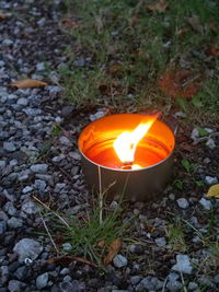 High angle view of lit candles on field