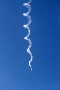 Spiral vapor trail in clear blue sky