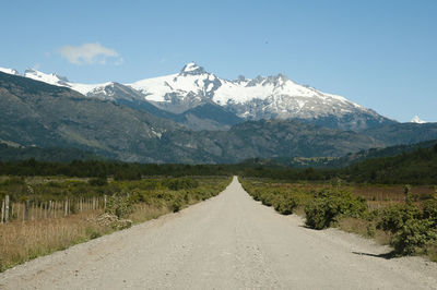 Road amidst mountains against sky