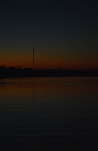 Scenic view of lake against orange sky