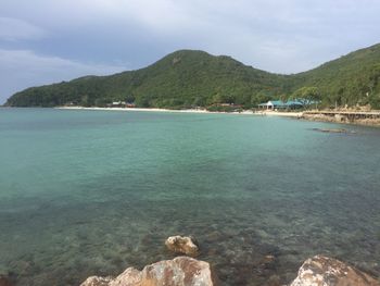 Scenic view of sea and mountains against sky