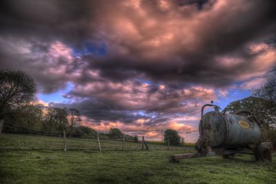 Scenic view of field against dramatic sky
