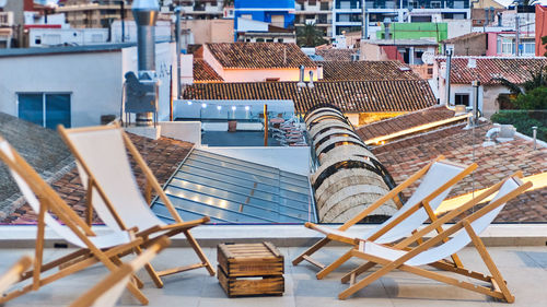 High angle view of chairs on table against buildings