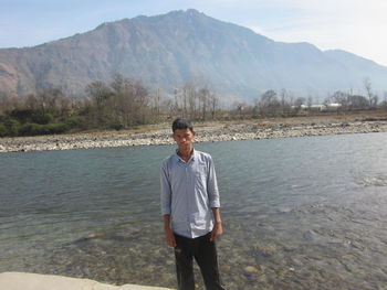 Full length of man standing on lake