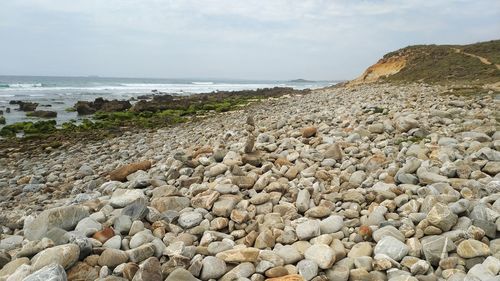 Rocks on beach against sky