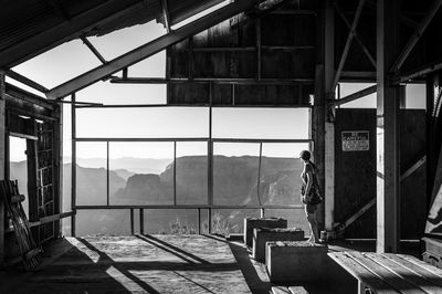 Woman looking at landscape from old observation point