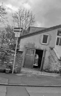 Exterior of house by building against sky