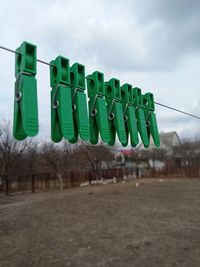 Low angle view of chairs on field against sky