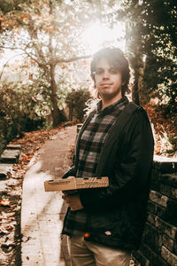 Portrait of young man standing on land