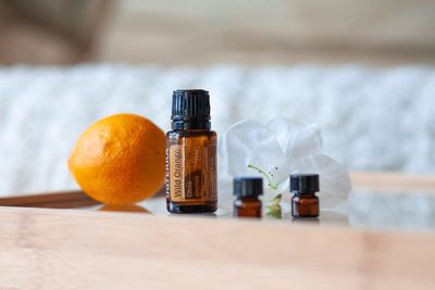 Close-up of essential oils by orange on table