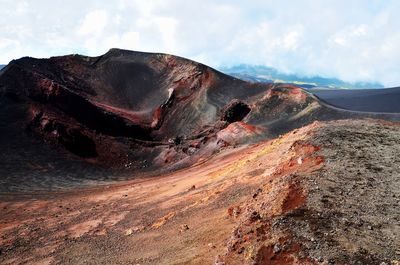 View of volcanic landscape against cloudy sky