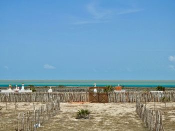 Scenic view of cemetery in a beach against blue sky