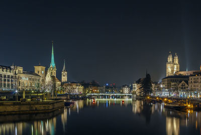 Limmat river with view of churchs in zurich in evening, switzerland