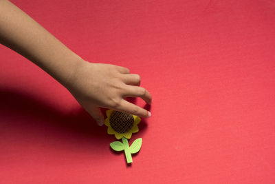 Close-up of hand holding red toy