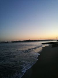 Scenic view of sea against clear sky at sunset