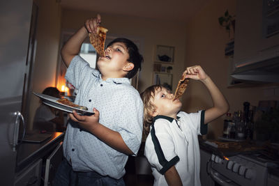 Boys eating pizza