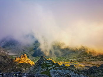 Mountain valley in the clouds lit by the setting sun. tatra mountains slovakia.