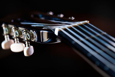 Close-up of guitar against black background