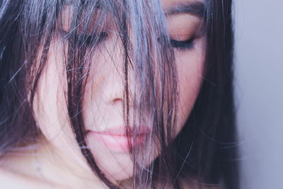 Close-up of young woman with messy hair at home