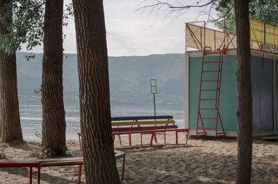Wooden posts on beach against sky