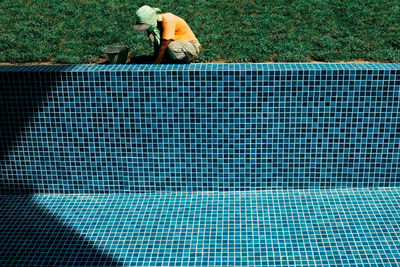 High angle view of man working at swimming pool