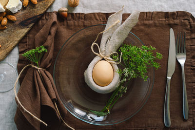 Happy easter. stylish easter eggs on a napkin with spring flowers on white wooden background