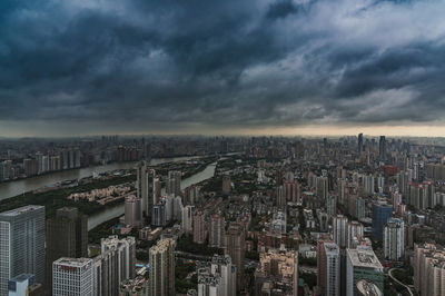 High angle view of city against cloudy sky