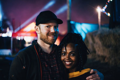Portrait of smiling young man at night