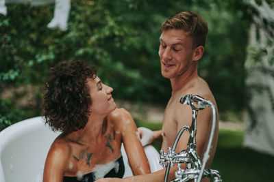 Young couple sitting outdoors