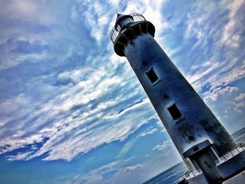 Low angle view of tower against cloudy sky