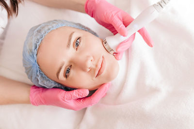 High angle view of young woman doing beauty treatment