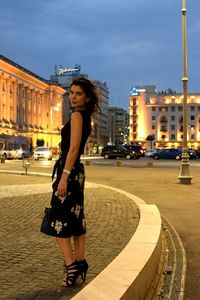 Young woman looking at city street